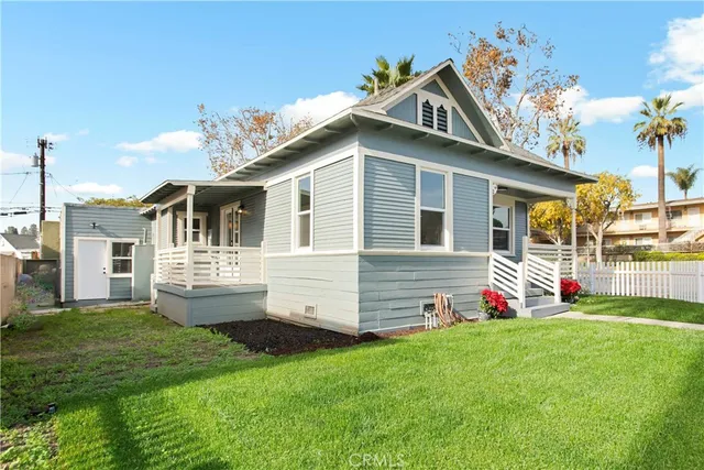 a view of a house with a yard and pathway