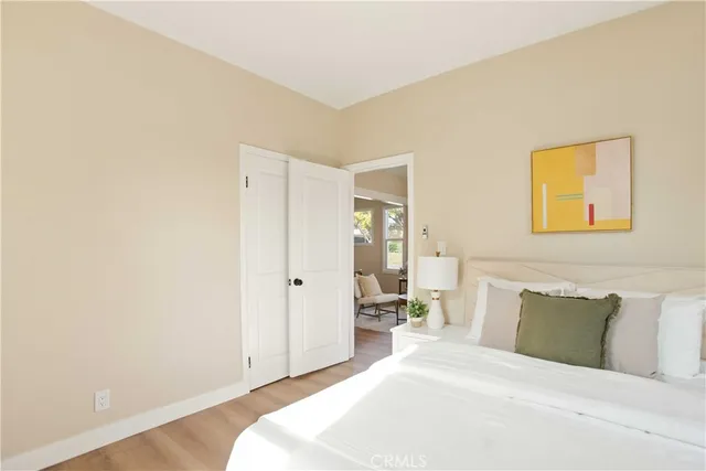 a bedroom with a bed and a painting on the wall