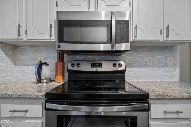 a stove top oven sitting inside of a kitchen