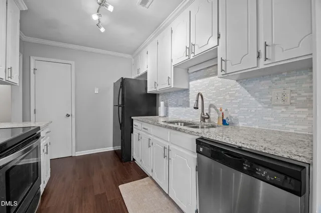 a kitchen with stainless steel appliances granite countertop a sink stove and refrigerator