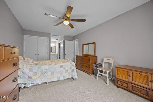 a bedroom with a bed dresser and a window