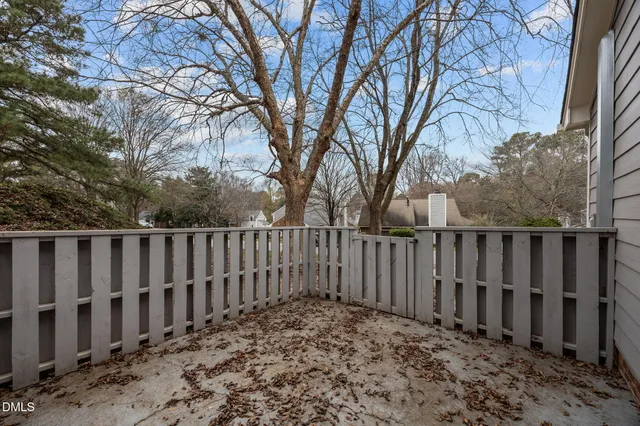 a wooden fence with trees in the background