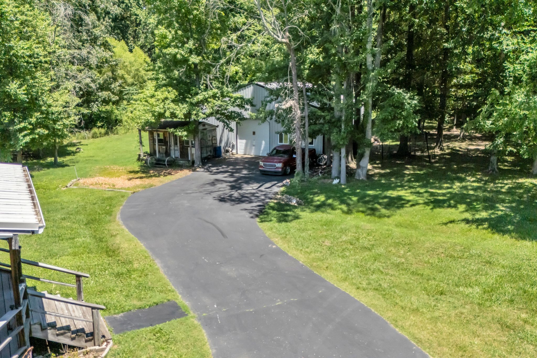 4111 Highway 49 Springfield, TN 37172 - Photo 41 of 46 a view of a backyard with table and chairs potted plants and large trees