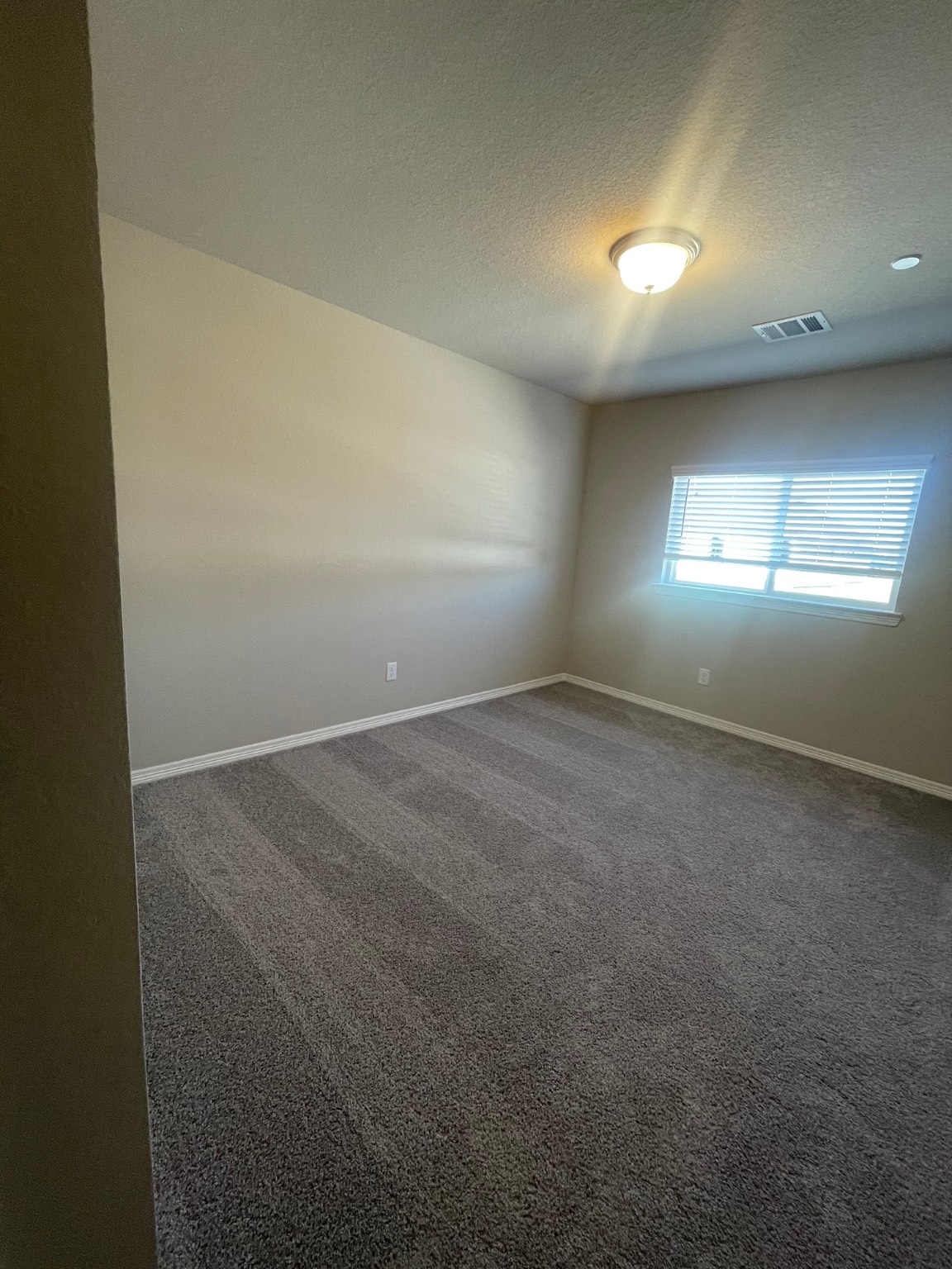 8024 Scanlan Trail Missouri City, TX 77459 - Photo 8 of 11 an empty room with windows and closet