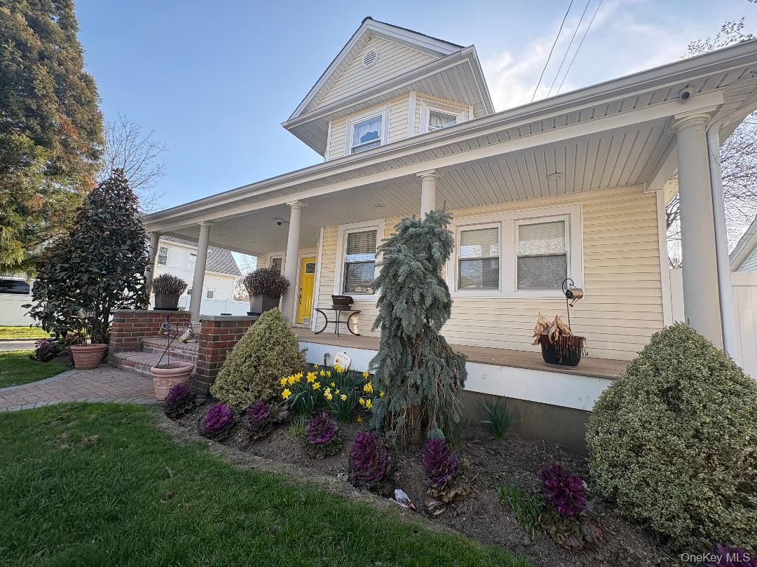 25 Rutland Road Freeport, NY 11520 - Photo 1 of 31 a front view of a house with garden