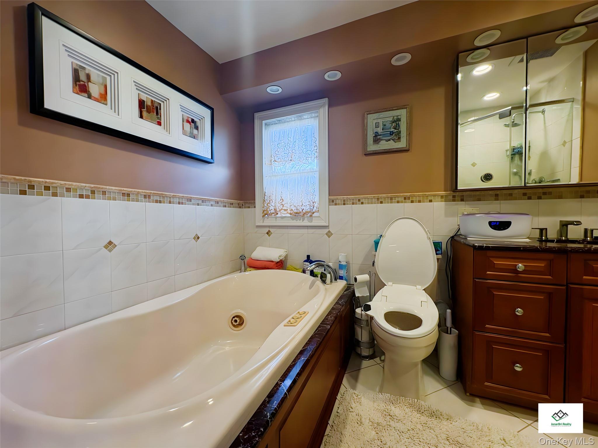 25 Rutland Road Freeport, NY 11520 - Photo 28 of 31 a bathroom with a sink and a bathtub