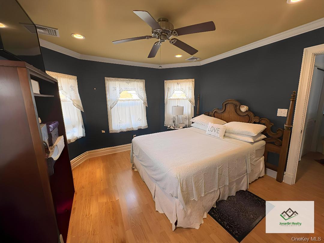 25 Rutland Road Freeport, NY 11520 - Photo 29 of 31 a bedroom with a bed and a mirror