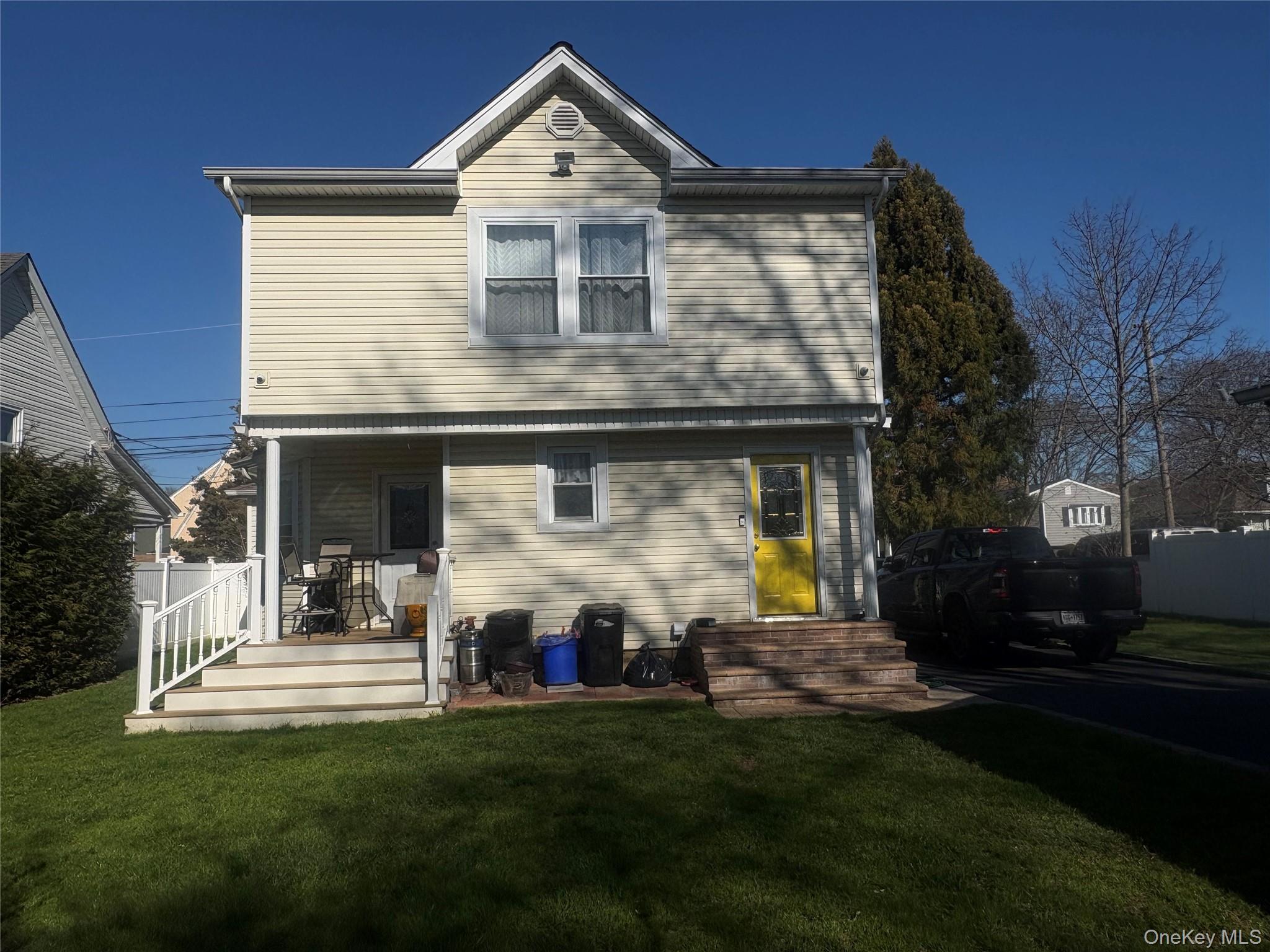 25 Rutland Road Freeport, NY 11520 - Photo 3 of 31 a front view of a house with a yard
