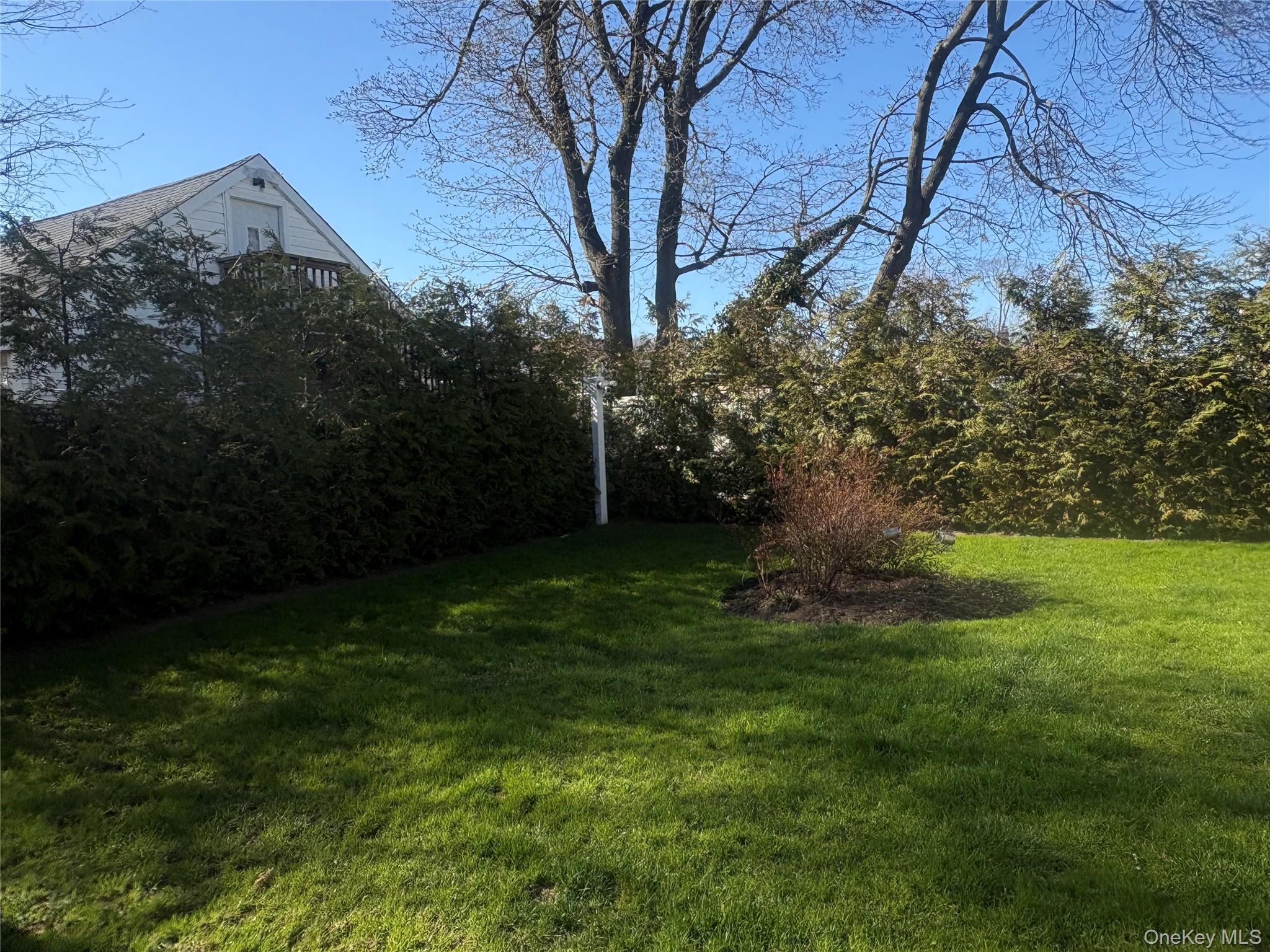 25 Rutland Road Freeport, NY 11520 - Photo 4 of 31 a backyard of a house with lots of green space