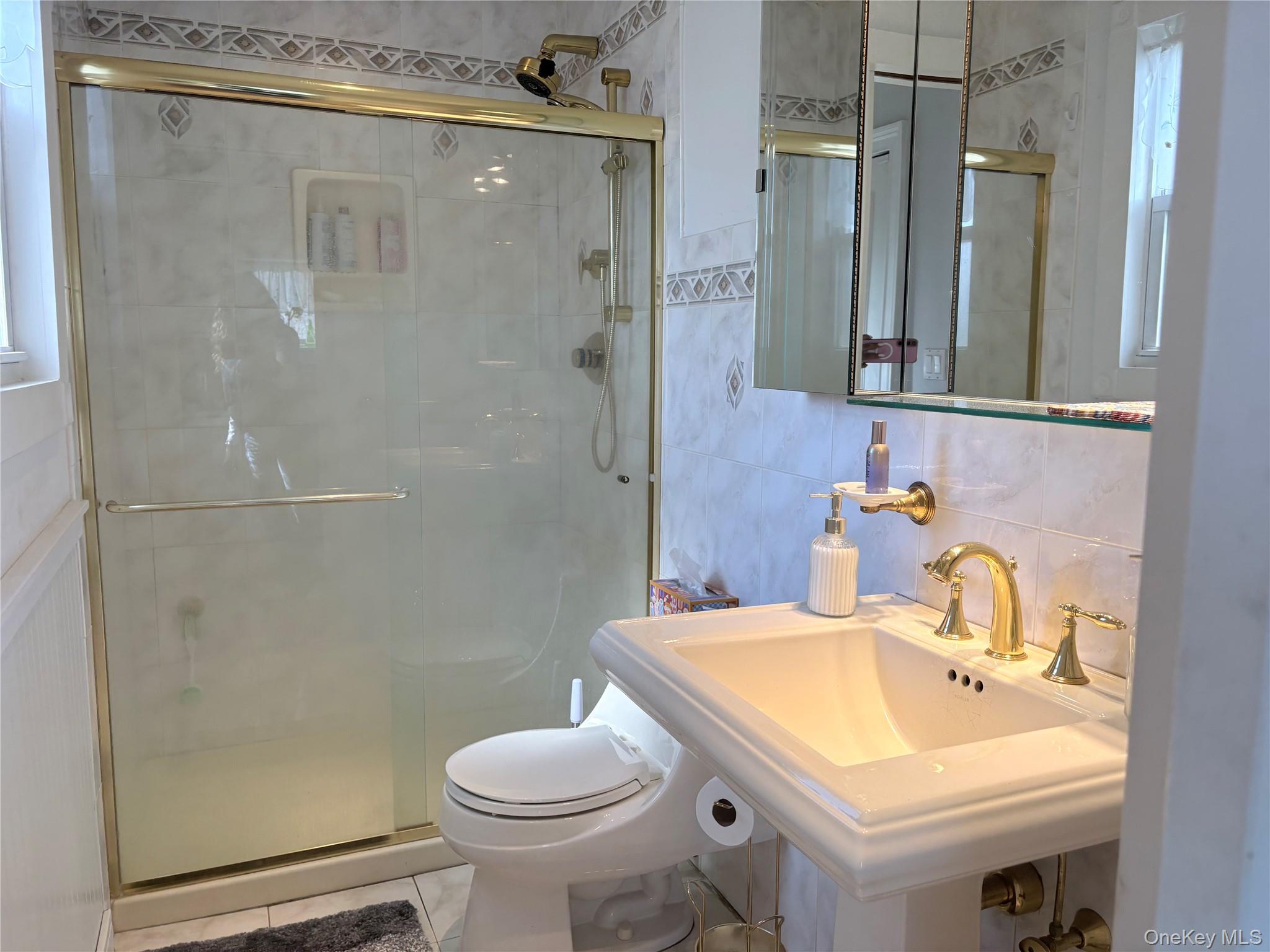 25 Rutland Road Freeport, NY 11520 - Photo 7 of 31 a bathroom with a sink toilet and shower