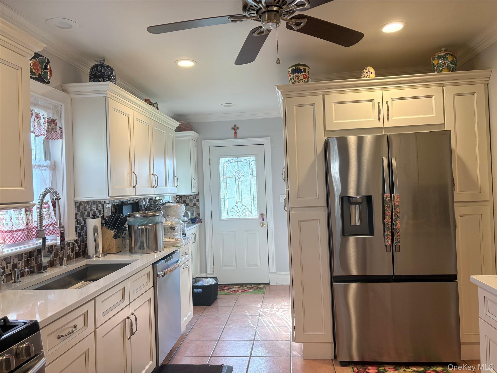 25 Rutland Road Freeport, NY 11520 - Photo 8 of 31 a kitchen with stainless steel appliances granite countertop a refrigerator and a sink