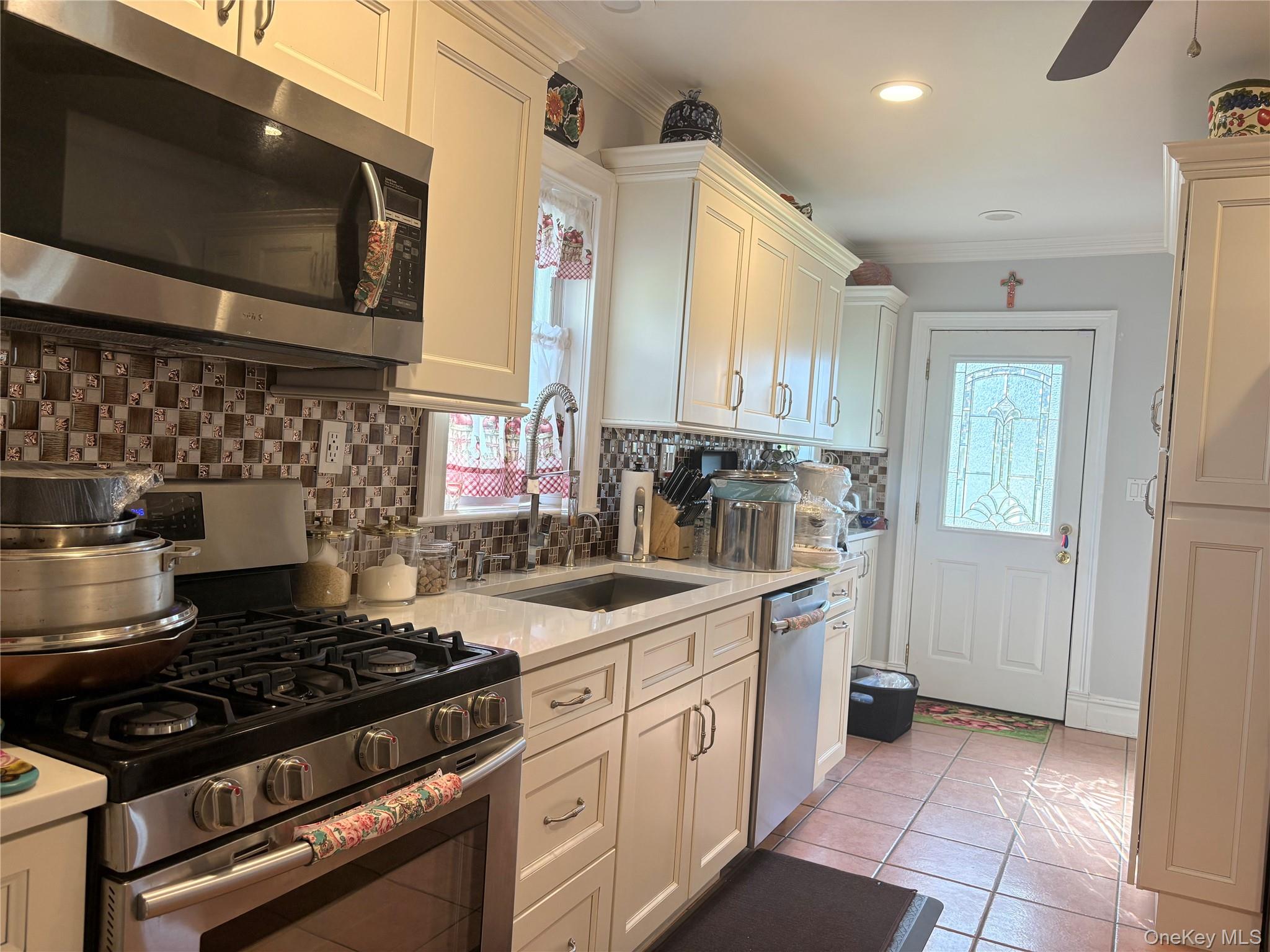 25 Rutland Road Freeport, NY 11520 - Photo 9 of 31 a kitchen with a stove and a microwave