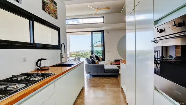 a kitchen with stainless steel appliances kitchen island granite countertop a stove and a refrigerator