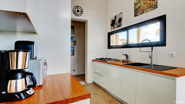 a kitchen with stainless steel appliances a sink cabinets and wooden floor