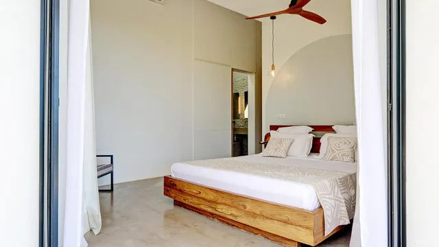 a bedroom with a bed and a table