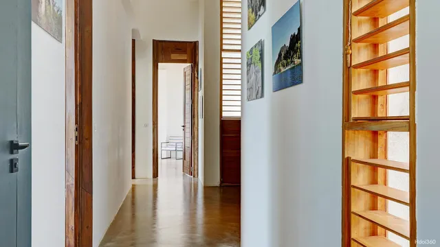 a view of hallway with wooden floor