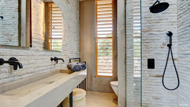 a bathroom with a granite countertop sink and a window