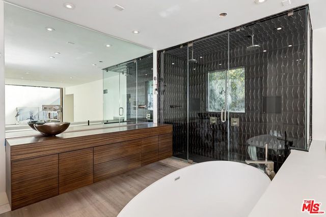 a bathroom with double vanity and a bathtub