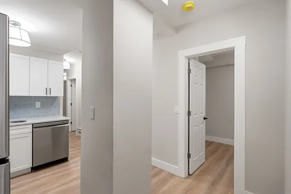 a view of a kitchen from a hallway