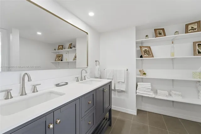 a bedroom with a bed and a flat tv screen on the wall