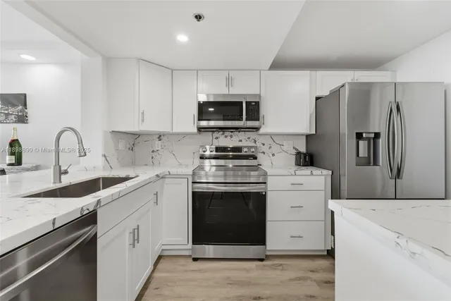 a kitchen with a sink stove and microwave