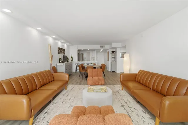 a living room with furniture or kitchen view and a large window