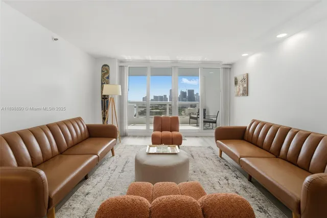 a spacious bedroom with a bed a couch and large window