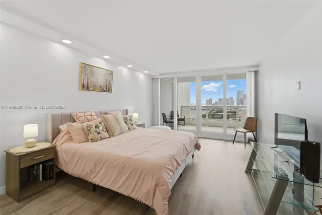 a bedroom with a bed and glass window