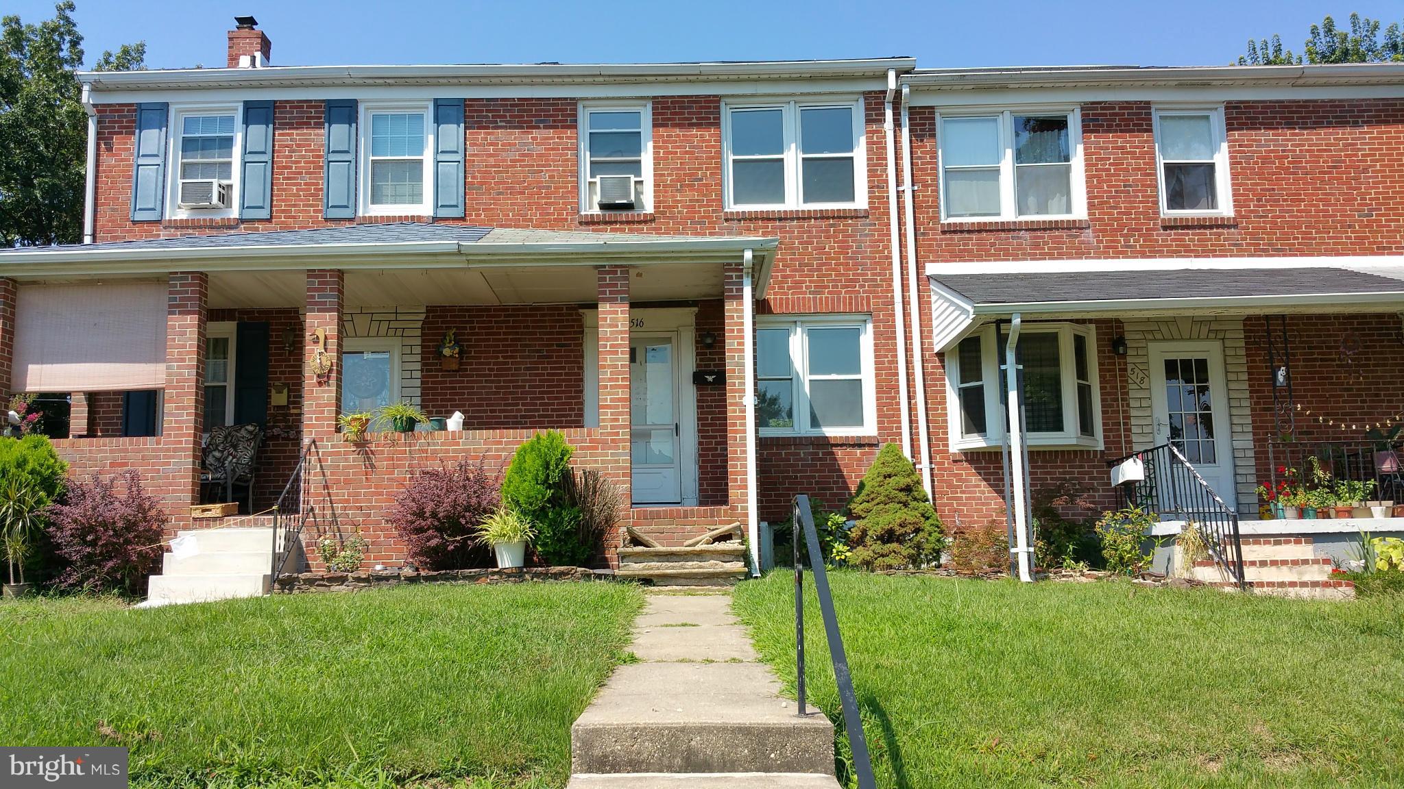 516 Chalcot Square Baltimore, MD 21221 - Photo 1 of 10 a front view of a house with garden