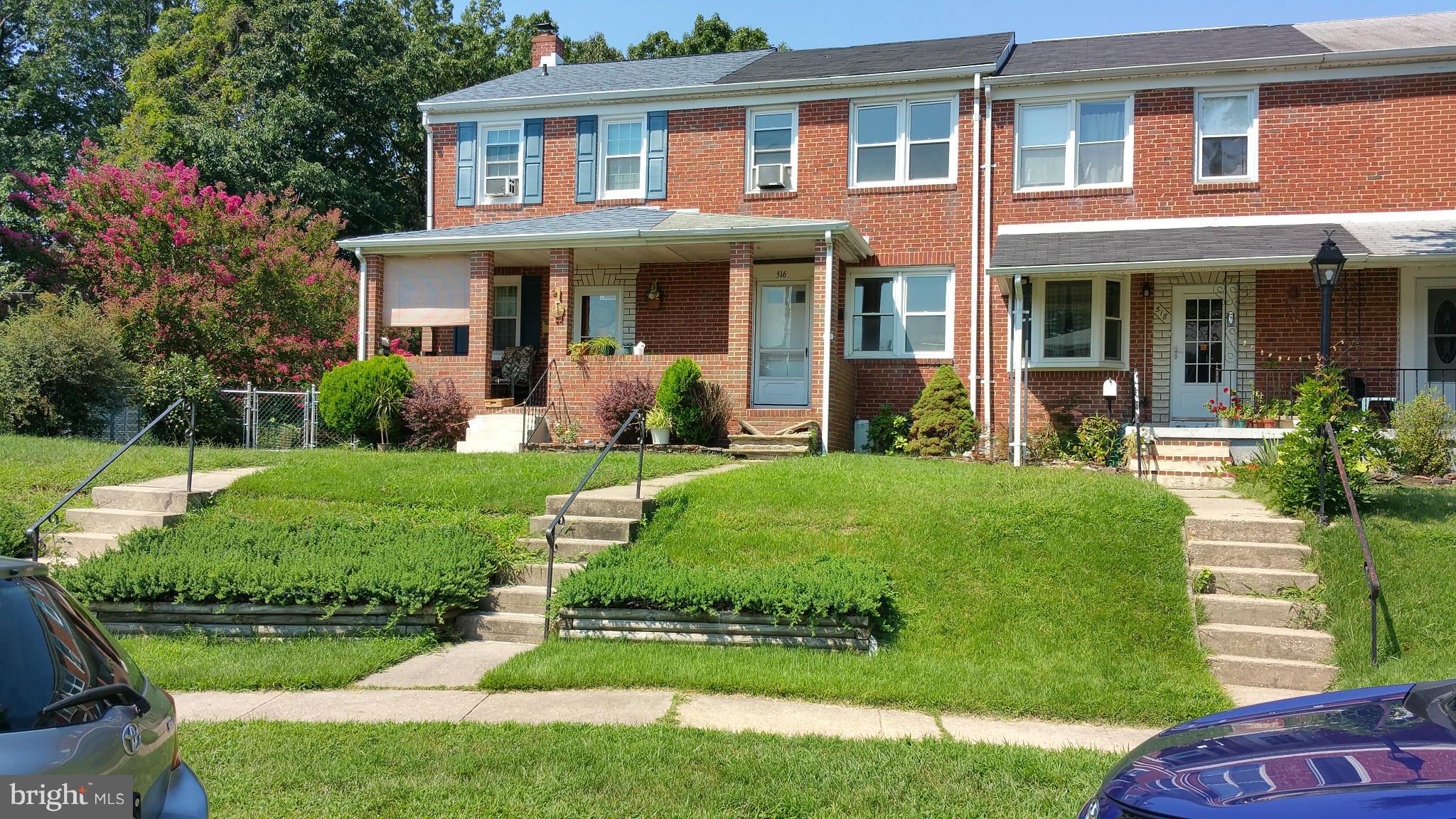 516 Chalcot Square Baltimore, MD 21221 - Photo 2 of 10 front view of a house with a yard