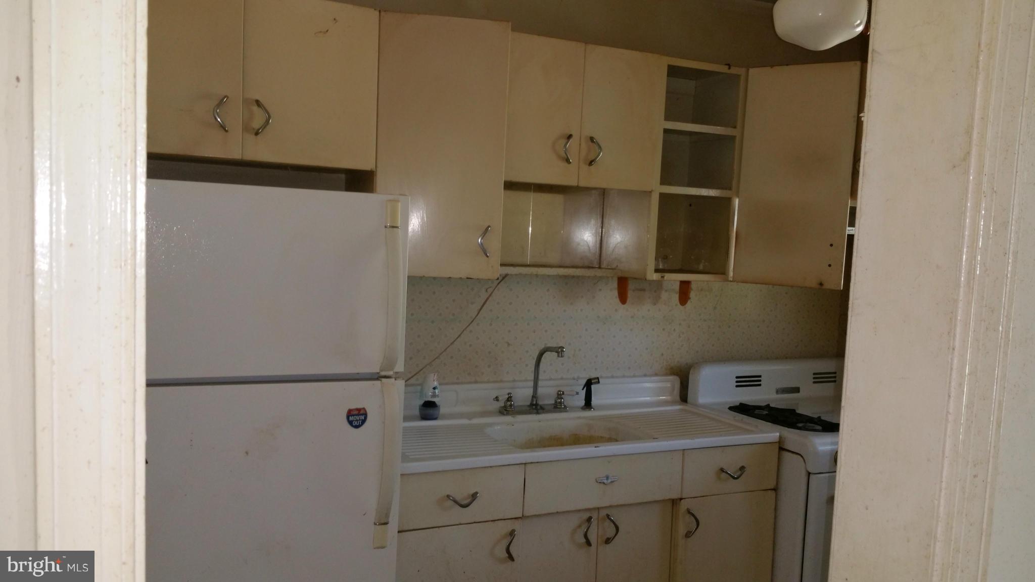 516 Chalcot Square Baltimore, MD 21221 - Photo 6 of 10 a kitchen with a sink and a refrigerator