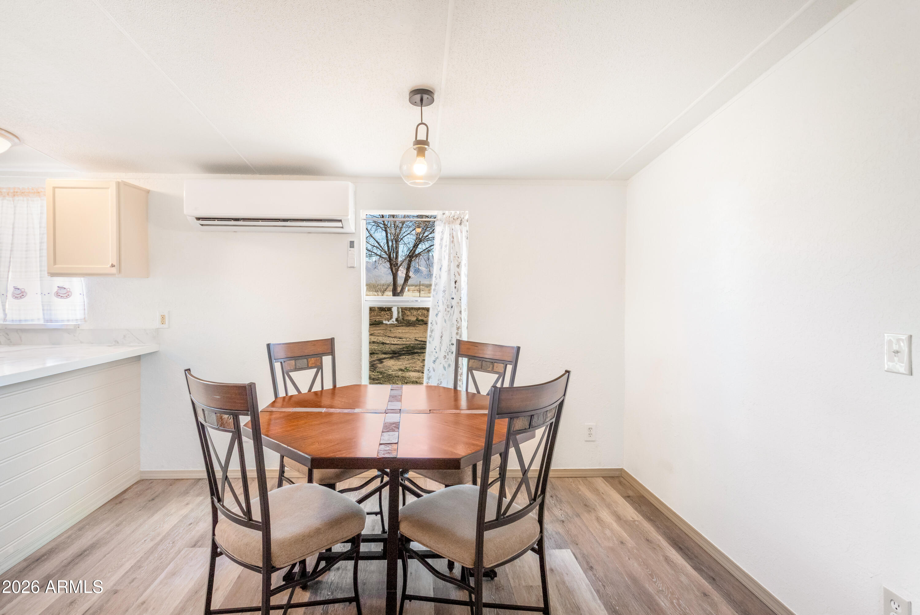 10405 North Mormon Road Elfrida, AZ 85610 - Photo 10 of 43 a view of a dining room with furniture and wooden floor