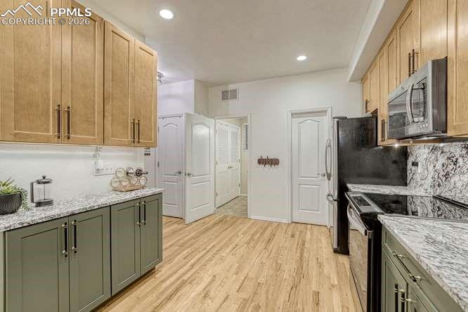 12365 Point Reyes Drive Peyton, CO 80831 - Photo 13 of 44 Kitchen with new cabinets, hardwood, new range.