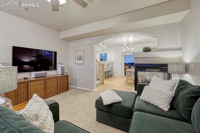 12365 Point Reyes Drive Peyton, CO 80831 - Photo 8 of 44 Living Room, carpeted with fireplace and open concept into the dining room.