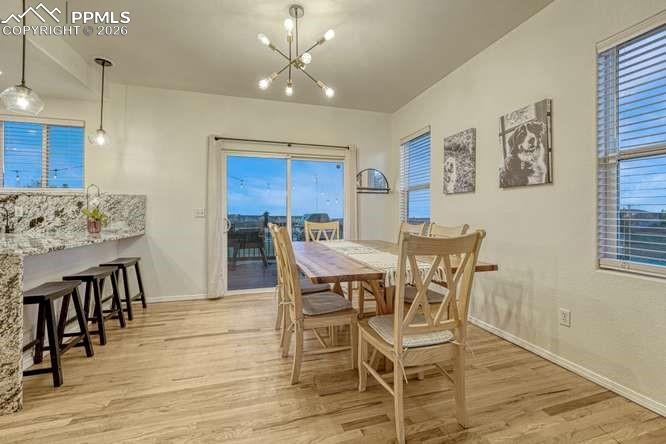 12365 Point Reyes Drive Peyton, CO 80831 - Photo 10 of 44 Dining Area with sliding door out to the deck. Breakfast bar with marble countertops.