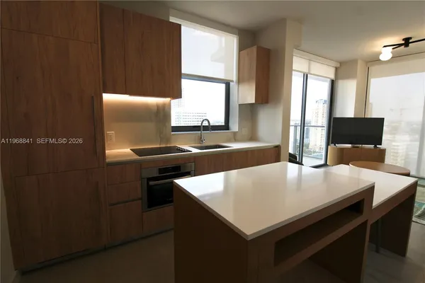 a kitchen with a table chairs and a refrigerator