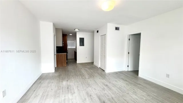 a view of hallway with wooden floor
