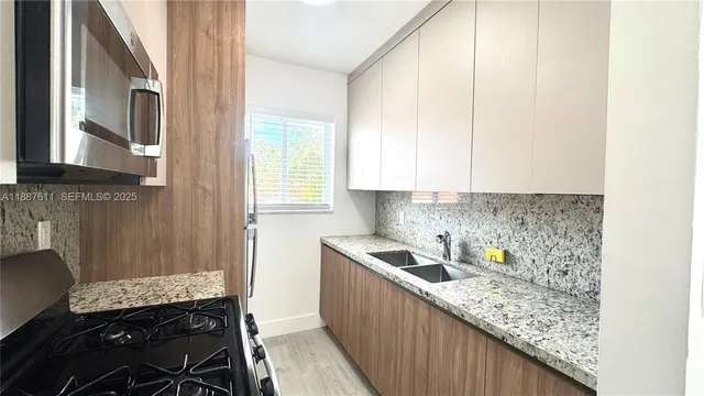 a kitchen with a sink and cabinets