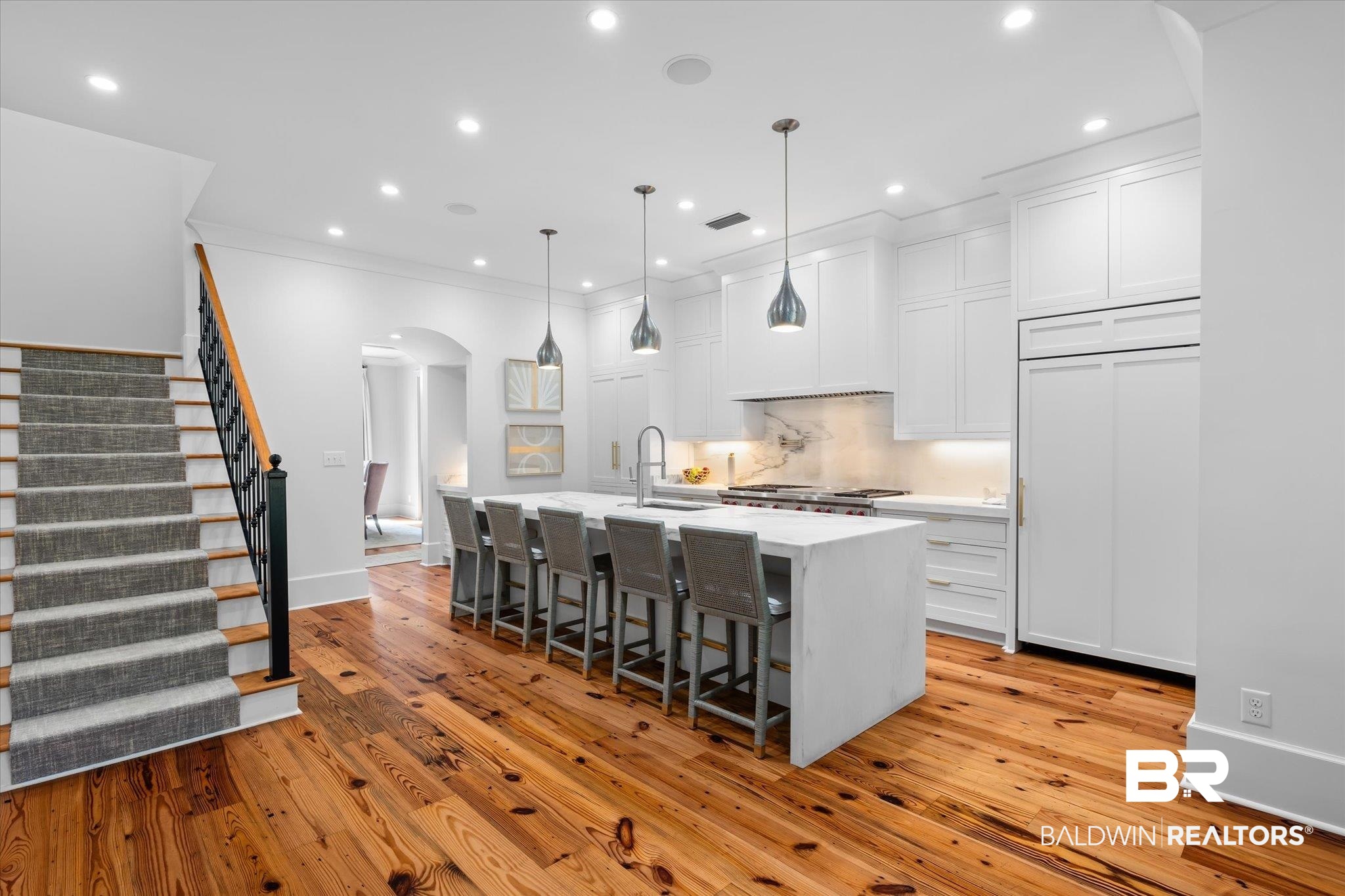 320 Long Court Mobile, AL 36608 - Photo 15 of 61 Kitchen with a kitchen island with sink, white cabinetry, a kitchen bar, light hardwood / wood-style flooring, and decorative light fixtures