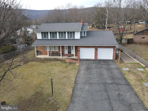 a aerial view of a house with a yard