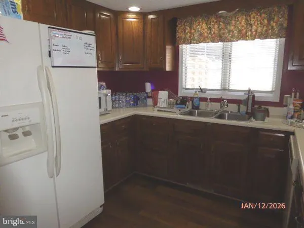 a kitchen with stainless steel appliances a stove microwave and refrigerator
