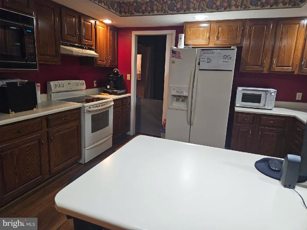 81 Lester Street Keyser, WV 26726 - Photo 14 of 75 a kitchen with a refrigerator sink and cabinets