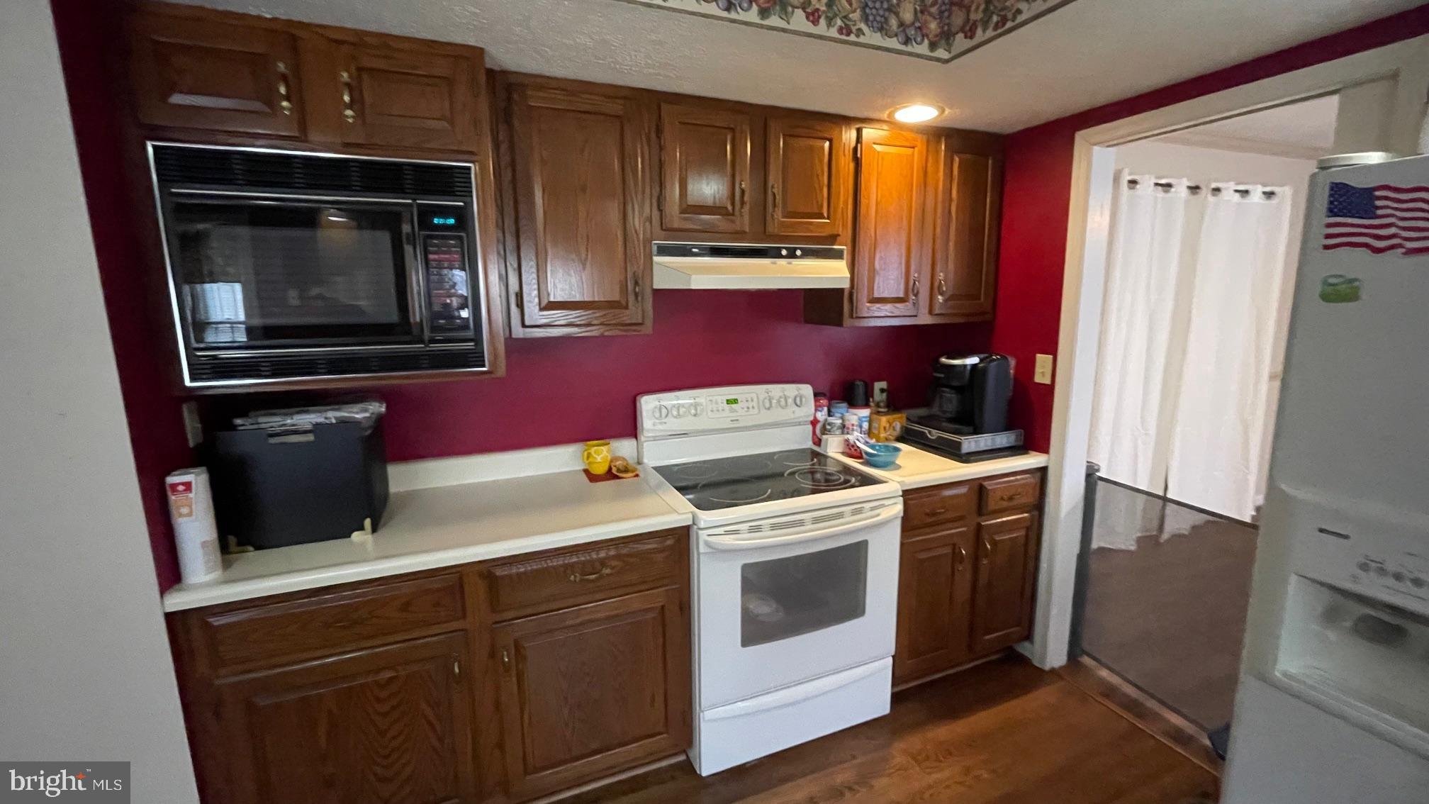 81 Lester Street Keyser, WV 26726 - Photo 17 of 75 a kitchen with a stove microwave and refrigerator