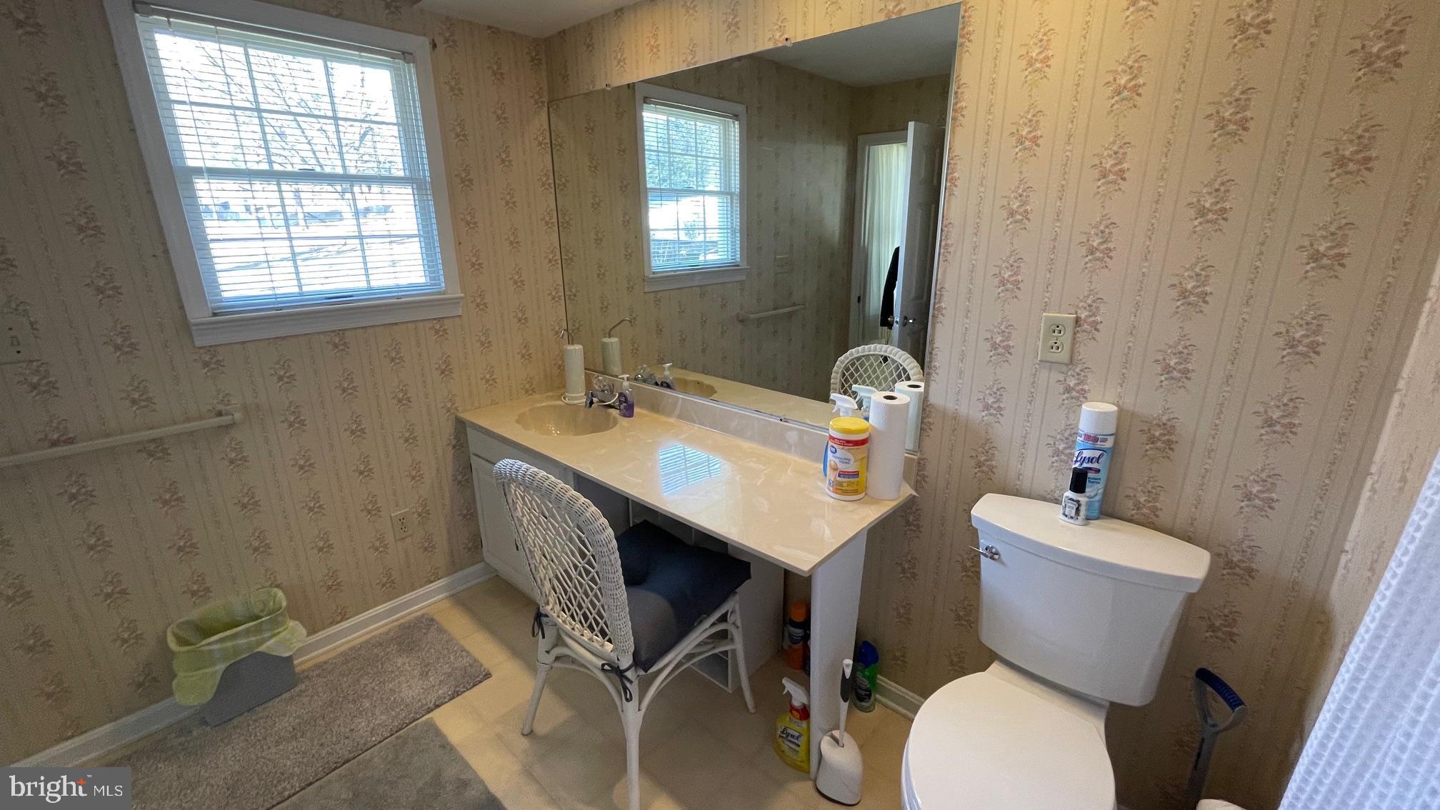 81 Lester Street Keyser, WV 26726 - Photo 35 of 75 a bathroom with a sink mirror toilet and next to a window