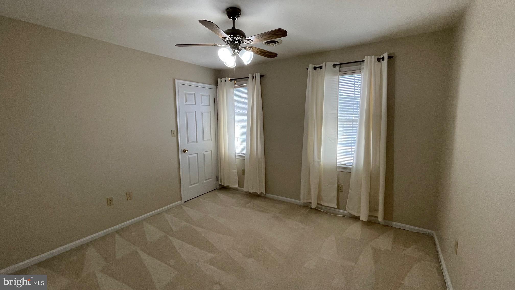81 Lester Street Keyser, WV 26726 - Photo 36 of 75 an empty room with chandelier fan and windows