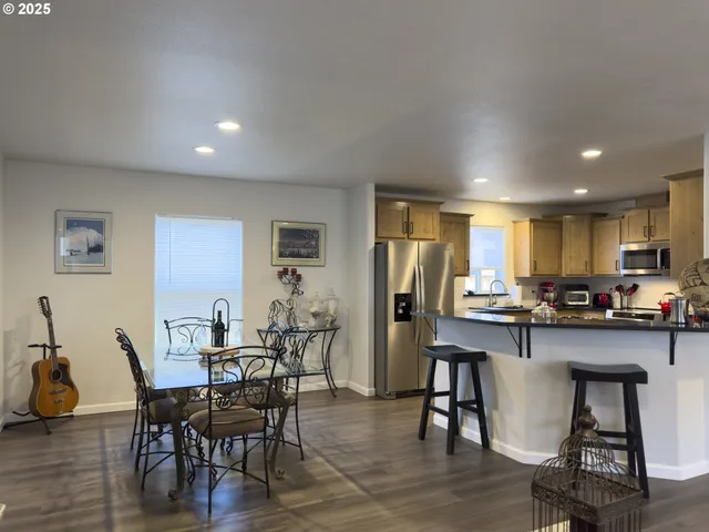 a kitchen with stainless steel appliances granite countertop a sink counter space and wooden floor