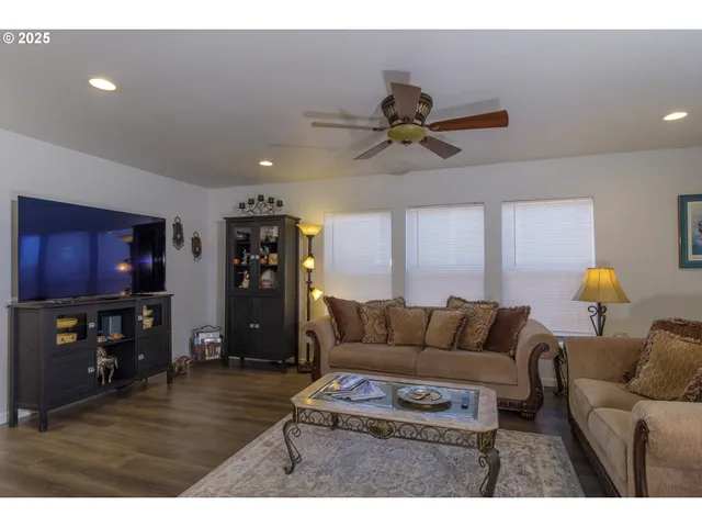 a living room with furniture and kitchen view