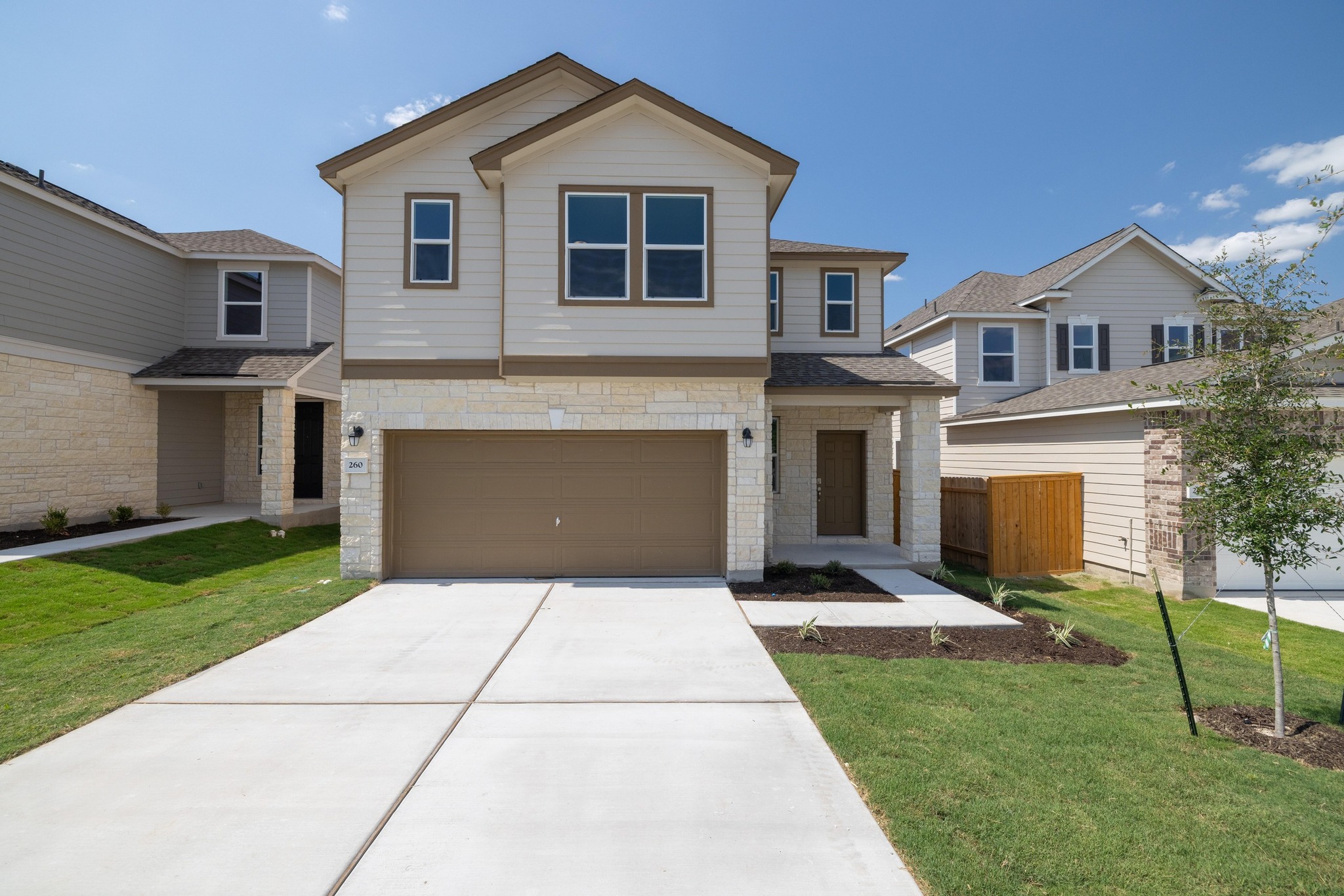 a front view of a house with a yard and outdoor seating