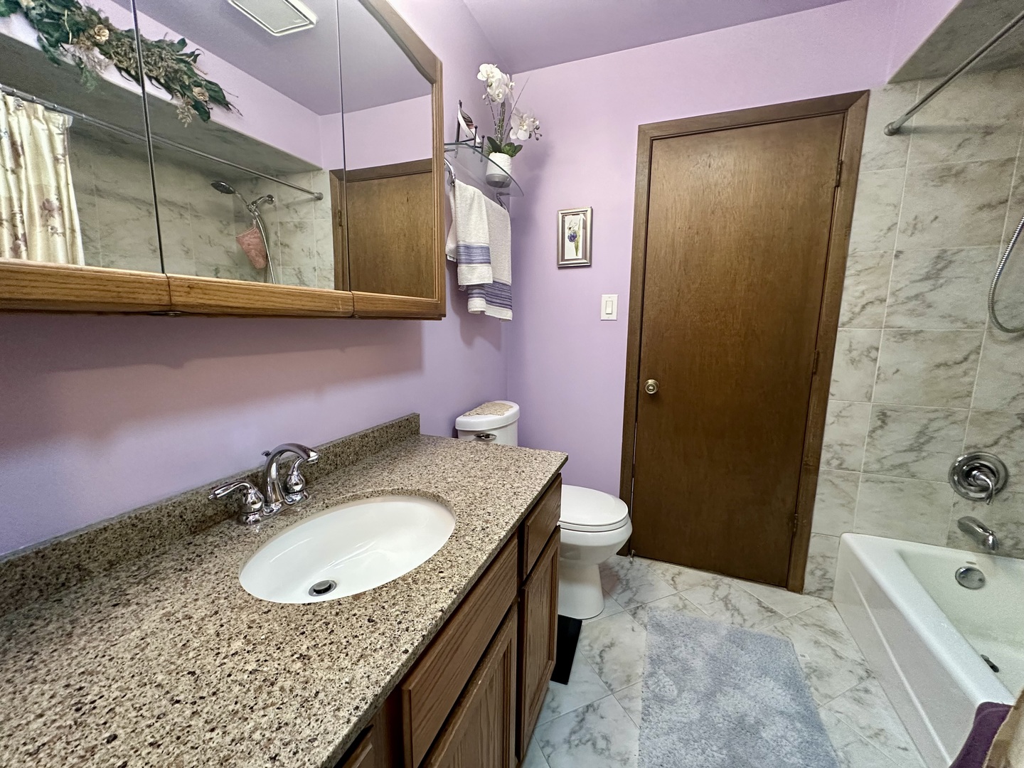 15813 Jon Road Oak Forest, IL 60452 - Photo 17 of 31 a bathroom with a granite countertop sink a toilet a mirror and shower
