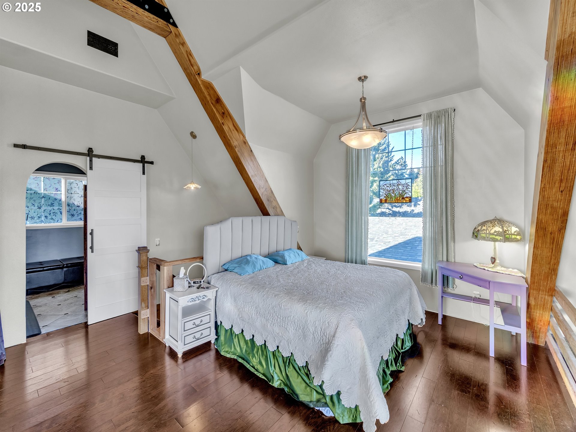 90589 Clark Road Warrenton, OR 97146 - Photo 18 of 48 a bedroom with a bed wooden floor and a window